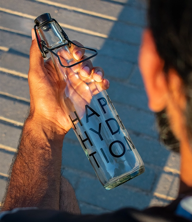 Glass water bottle with Happy Hydration logo